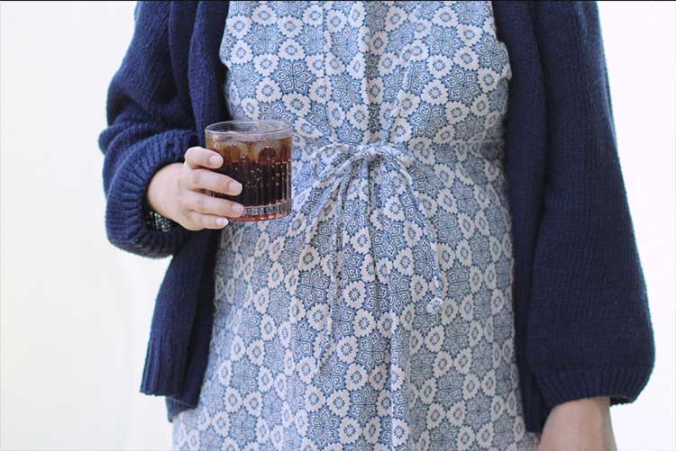 Pregnant woman holding a glass of soft drink