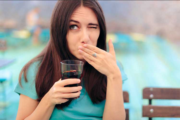 Woman holding a glass of soft drink