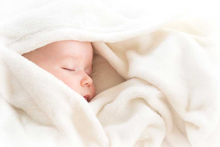 A baby wrapped up in too many warm clothes could wake up with night sweat.