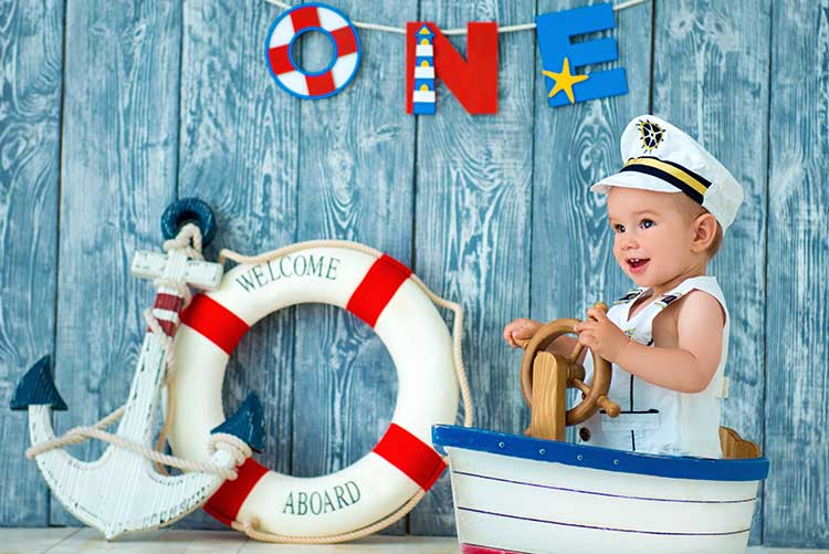 A baby boy enjoying is sailor's photoshoot.