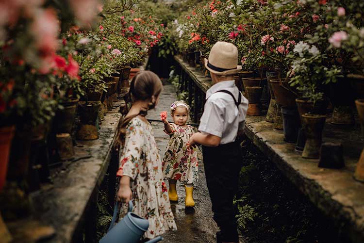 A group of kids standing around in a garden.