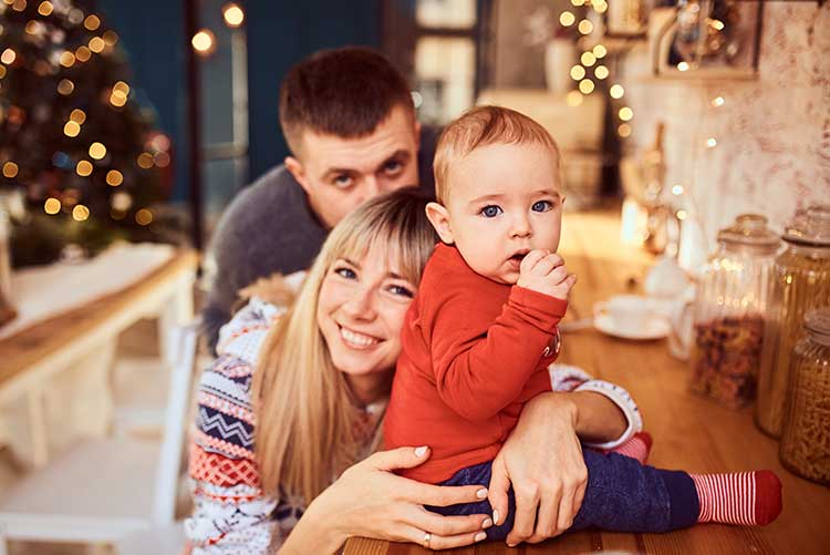 A young family posing for a picture.