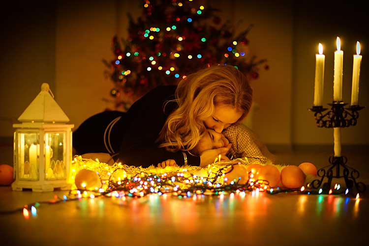 A mother and son at a fairy-light themed photoshoot for babies.