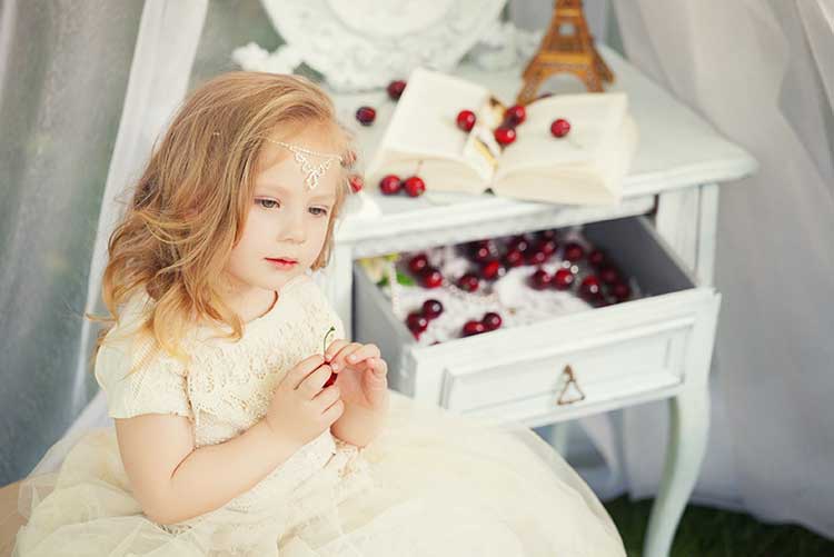 A girl looking in her Victorian-style photoshoot.