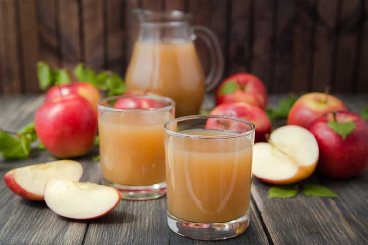 Apple juice next to apples